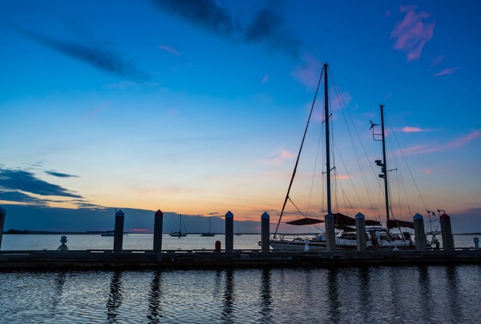 Sailboat docked in the harbor at dusk