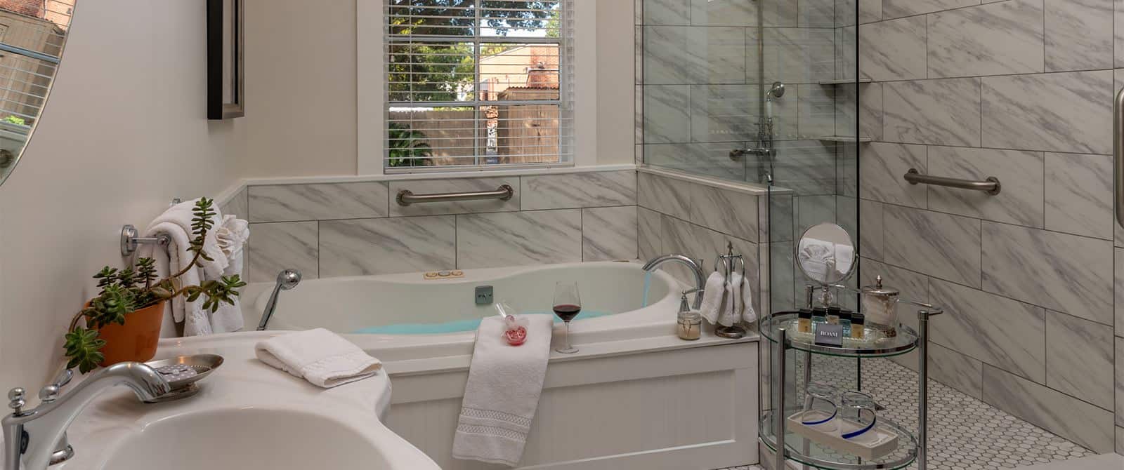 Bathroom with white walls, tiled flooring, walk-in shower, two-person jetted tub, and white sink