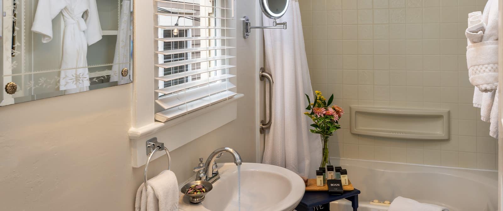 Bathroom with white walls, white sink, and white tub