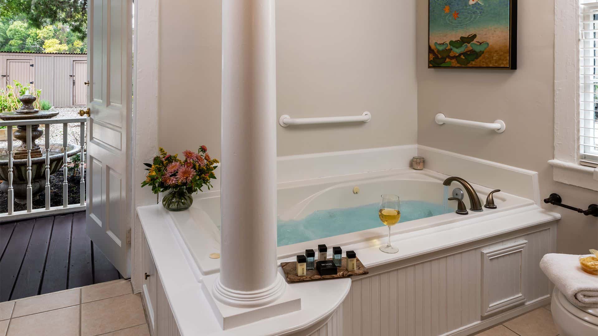 Bathroom with white walls, tiled flooring, and jetted tub