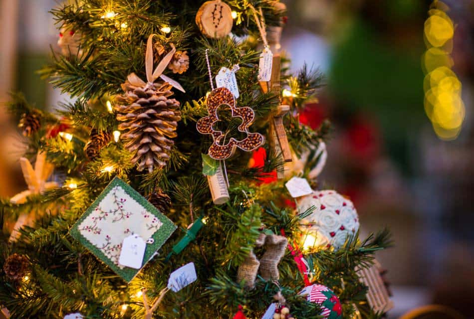 Close up of a Christmas tree decorated with many different types of ornaments