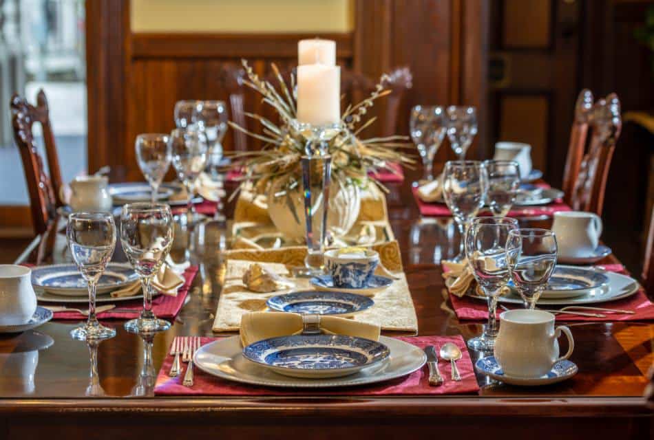 Dark wooden dining table with multiple place settings